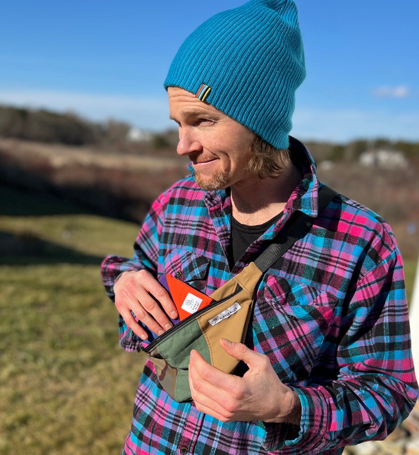 man wearing beanie and plaid flannel with fanny lifestyle