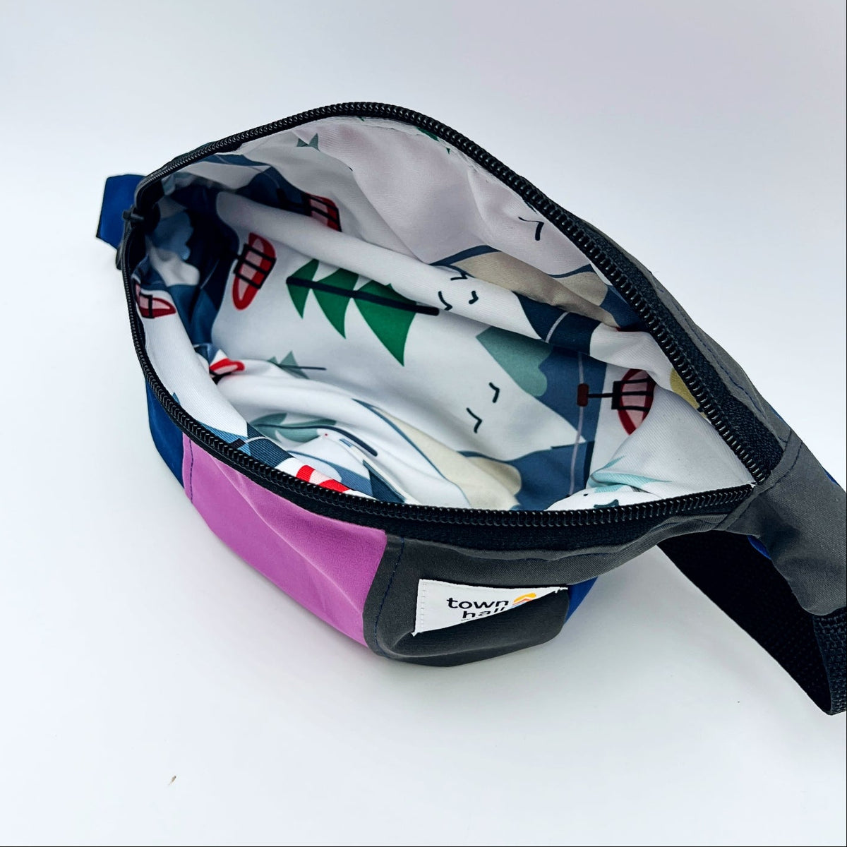 Multicolored waist bag with a patterned interior on a white background