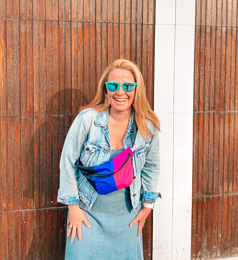 Kate Harvey, founder of BirdieBlue, wearing a bag made from recycled ski clothing